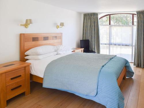 a bedroom with a large bed and a window at The Cart House in Westerdale