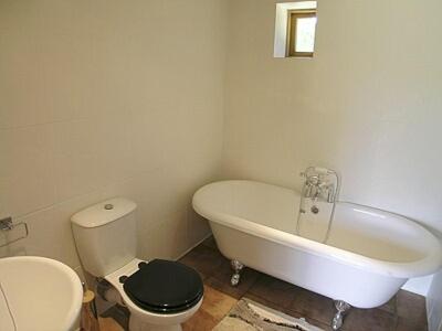 a bathroom with a toilet and a tub and a sink at The Old Packhouse in Steyning