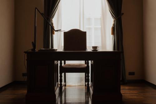 a desk with a chair in front of a window at Hotel Copernicus in Kraków