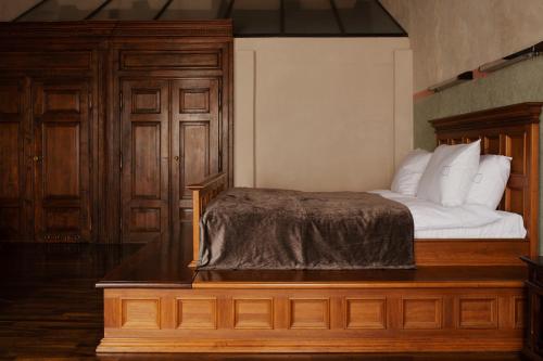 a bedroom with a bed with white pillows at Hotel Copernicus in Kraków