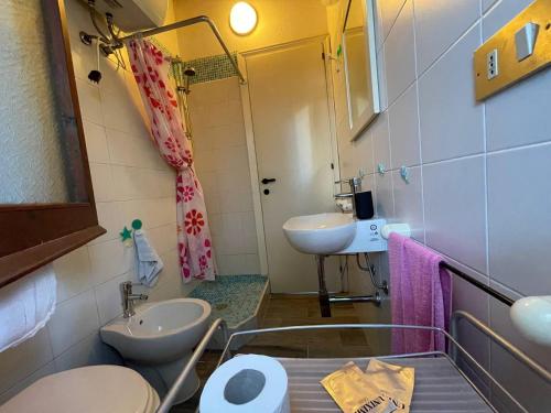 a small bathroom with a toilet and a sink at -EXCLUSIVE PRIVATE VILLA- Villasimius in Villasimius