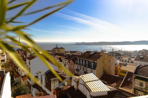 a view of a city with buildings and the ocean at Olympo Shared flat with Amazing River view in Lisbon