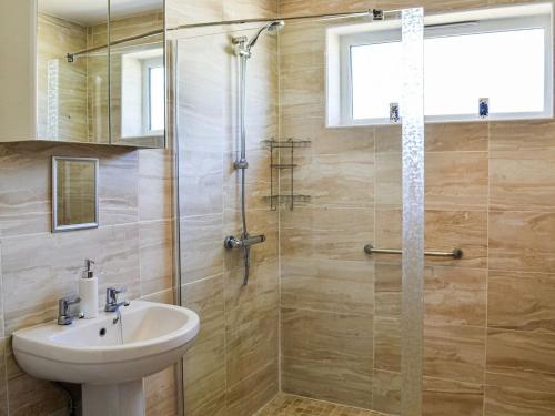 een badkamer met een wastafel en een douche bij Dovecote Annex in Mablethorpe