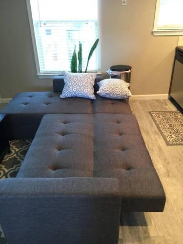 a large couch sitting in a living room at Walk Everywhere Heart of Downtown St Pete in St. Petersburg