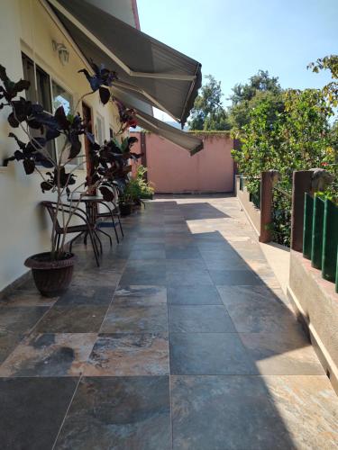 a patio with a table and an umbrella at Villas victoria mirador in Zihuatanejo