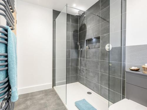 a shower with glass doors in a bathroom at Willow Cottage in Stonham Aspall