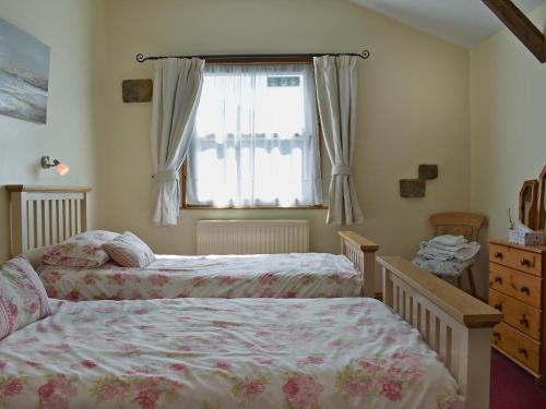 a bedroom with two beds and a window at Coble - 16262 in Staithes