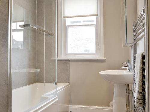 ein Bad mit einer Dusche und einem Waschbecken in der Unterkunft Blencathra House in Keswick