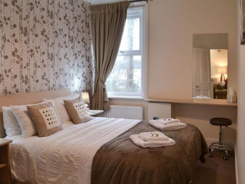 a bedroom with a bed with two towels on it at Robins Nest in Broomhill