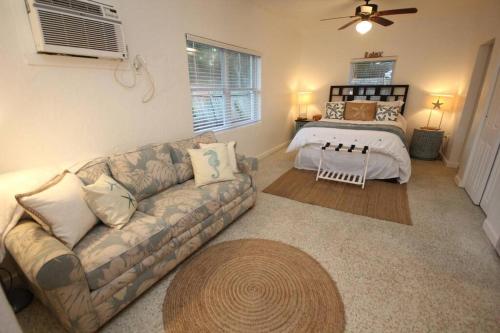 a living room with a couch and a bed at Cute Lil Oasis on Osprey in Sarasota