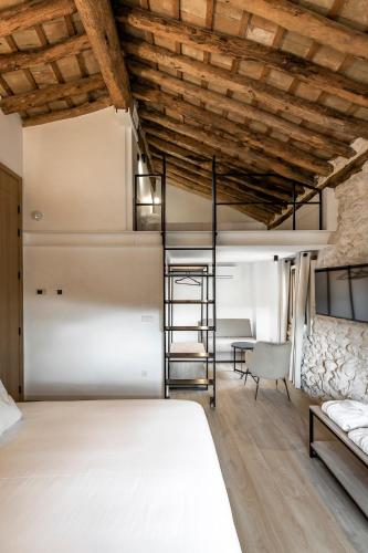a bedroom with a bed and a ladder in a room at ABBI Suites Casa Rural, Suites & Spa in Bocairent