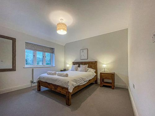a bedroom with a large bed and a window at Lavender Cottage in Stelling