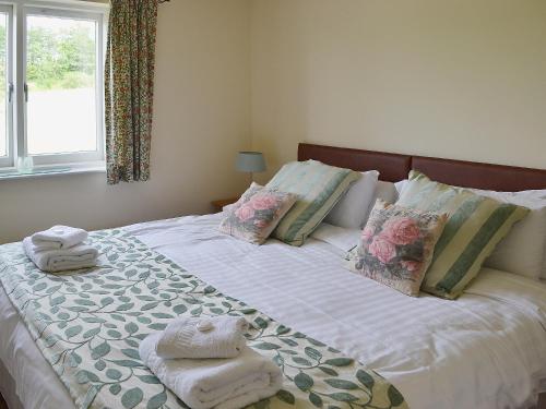a bedroom with a bed with towels on it at The Loft in Kirkby Lonsdale