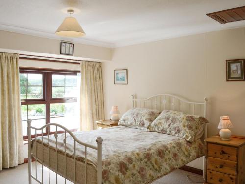 a bedroom with a bed and a window at Low Cordorcan - Uk5891 in Bargrennan