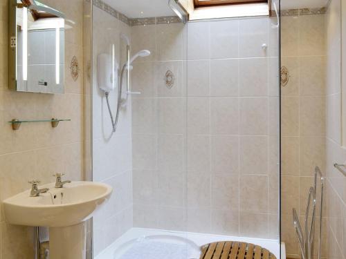 a bathroom with a shower with a sink and a toilet at Low Cordorcan - Uk5891 in Bargrennan