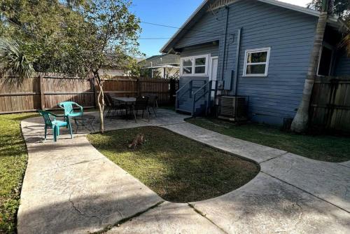 a cat sitting in the yard next to a house at Historic 1920 Bungalow Minutes from DTSP in St Petersburg