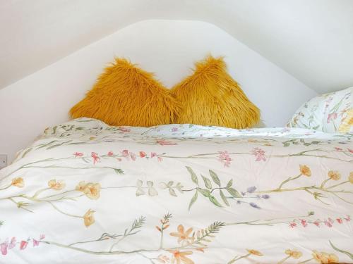 a bed with two pillows on top of it at Nant Aeron in Talsarn