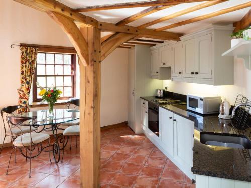 a kitchen with a table and a dining room at The Hayloft in Milnathort