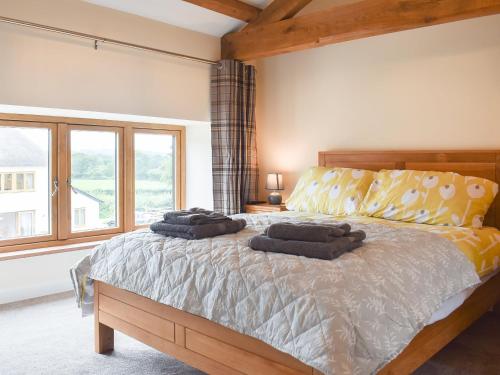 a bedroom with a bed with two pillows on it at North Barn in Monk Okehampton