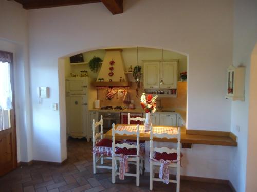 a kitchen with a table and chairs in a room at Suite "La Badia" in Scandicci