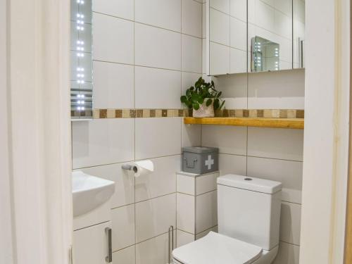 uma casa de banho branca com um WC e um lavatório em Ouse Retreat em York