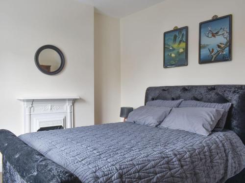 a bedroom with a bed and a mirror on the wall at Number One Bideford in Bideford