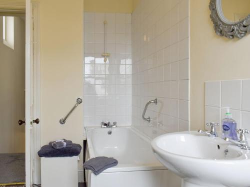 a bathroom with a sink and a tub and a toilet at Number One Bideford in Bideford