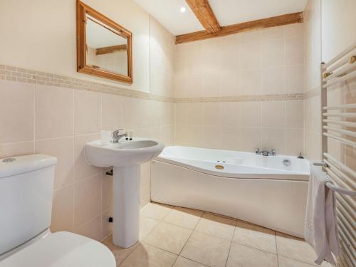 a bathroom with a sink and a tub and a toilet at The Grainery - Uk37516 in Routh