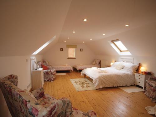 a bedroom with a bed and a living room at High Farm Barn in Brisley