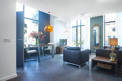 a living room with a couch and a table at Blush Appartement Centrum Middelburg in Middelburg