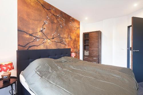 une chambre avec un lit et un tableau au mur dans l'établissement Blush Appartement Centrum Middelburg, à Middelbourg