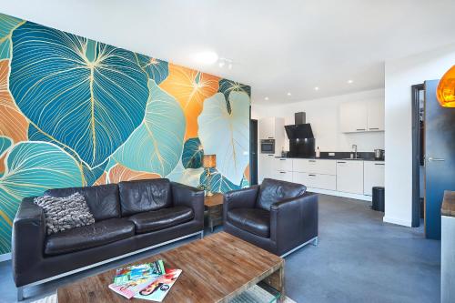 a living room with a couch and a table at Blush Appartement Centrum Middelburg in Middelburg