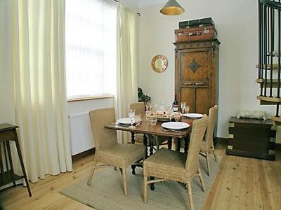 a dining room with a wooden table and chairs at The Aul Bank in Whitehills