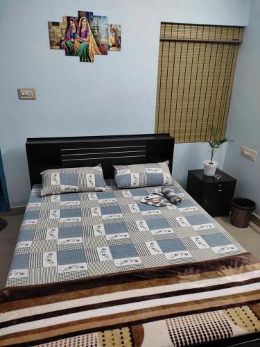 a bed with a quilt and pillows on it at Gruham Malpe Beach Homestay Udupi in Malpe