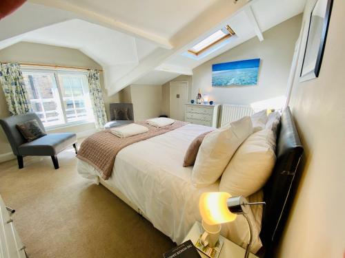 a bedroom with a large bed and a chair at The Coach House - 26154 in Corbridge