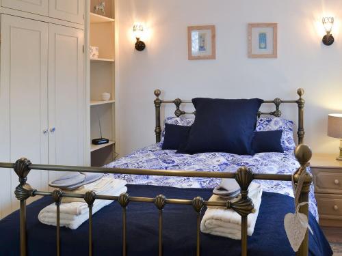 a bedroom with a bed with a blue comforter at Graces Retreat in Eryholme