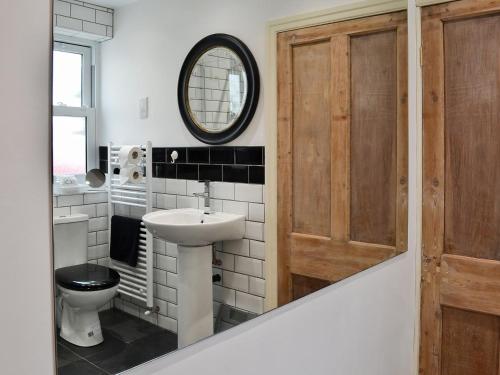 a bathroom with a sink and a toilet and a mirror at Graces Retreat in Eryholme