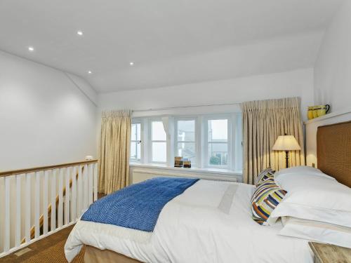 a bedroom with a large bed and a window at Healey Cottage in Kirkburton