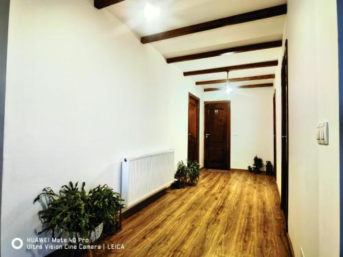 an empty hallway with potted plants in an apartment at Vatra Strabunilor in Moigrad