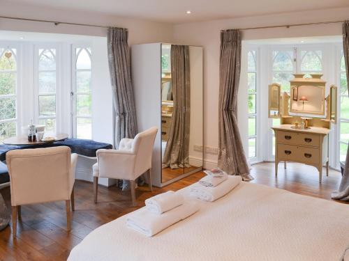 a bedroom with a bed and a table and chairs at Slowpool 