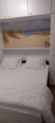 Een bed of bedden in een kamer bij Koksijde Gabbiano 104 en parking