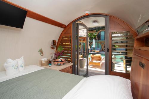 a bedroom with a bed and a view of a patio at Saranda Boutique Hotel in Puerto Viejo