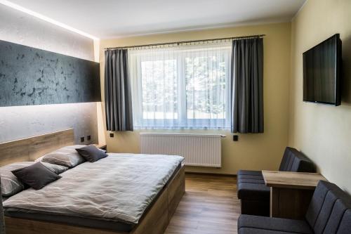 Postel nebo postele na pokoji v ubytování Penzion 2 sklepy