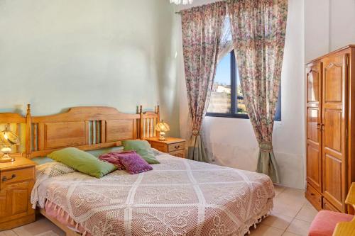 a bedroom with a bed and a window at Vila Morning Sun in Estreito da Calheta