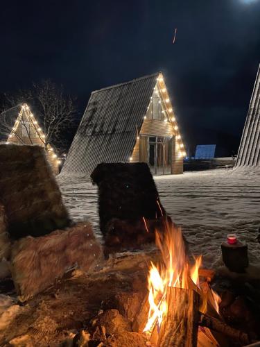a fire pit in front of a house with lights at Landhaus Borjomi in Borjomi