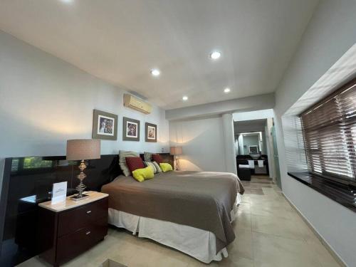 a bedroom with a large bed and a window at Piece of Paradise in the city in Guadalajara