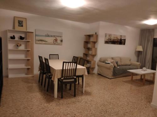 a living room with a table and chairs and a couch at Castellon Center Modern Spacious Apartment in Castellón de la Plana