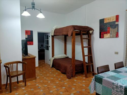 a bedroom with a bunk bed and a table at Vista Tunte, Camino de Santiago in San Bartolomé
