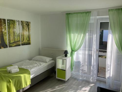 a small bedroom with a bed and a window at Zimmervermietung38 - Mammut 1 in Salzgitter