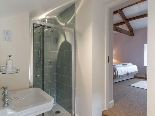 a bathroom with a shower and a sink at Helwith Cottage - Ukc3455 in Marrick